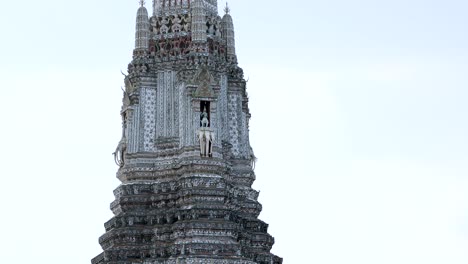 wat arun temple with birds flying around