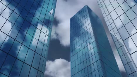 Animation-of-low-angle-view-of-tall-buildings-against-clouds-in-the-sky
