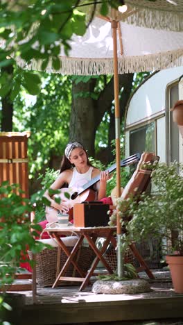 woman playing guitar outdoors on a patio