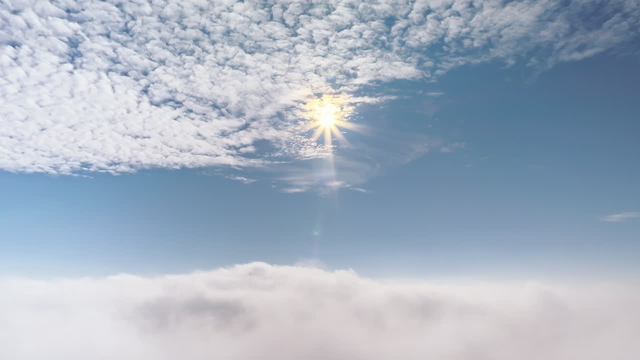 Aerial drone view of the sky with clouds and bright sun