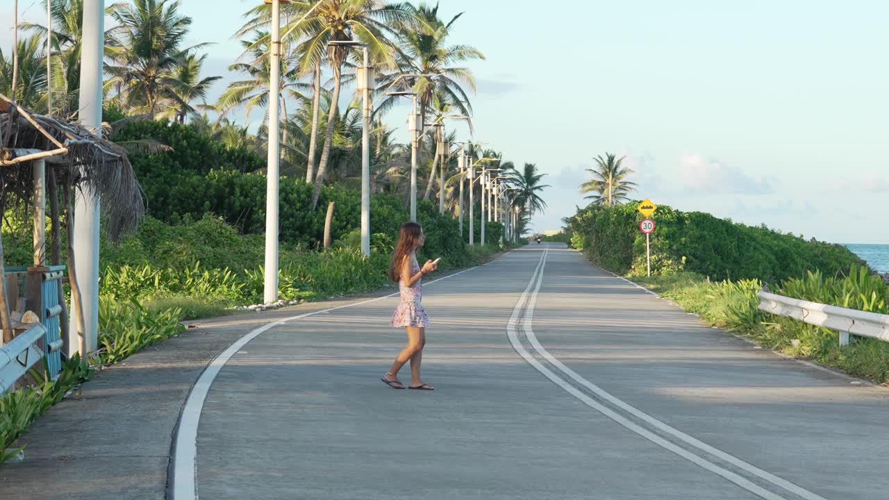 Young woman on holiday outside empty coastal road in San Andres island Colombia