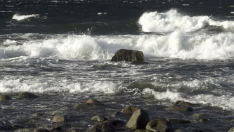 waves hitting wwii memorial rock in sea