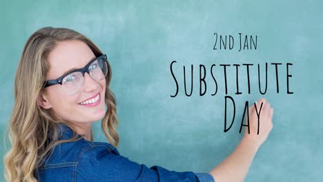 Animation-of-substitute-day-text-over-happy-caucasian-female-teacher-writing-on-green-chalkboard