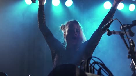 glamour woman singer dancing and immersed in music at nightclub stage close up