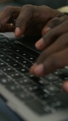 hands typing on a laptop keyboard