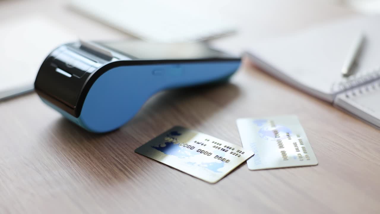 Credit cards and payment terminal on a desk