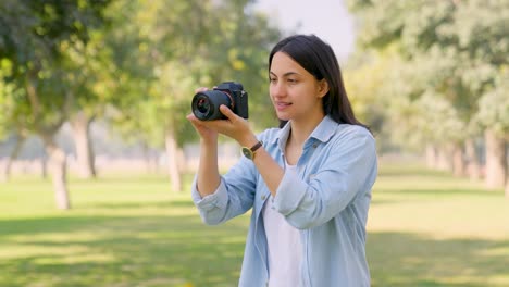 indian girl clicking photos using camera