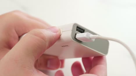 Man-connect-cable-for-charging-power-bank