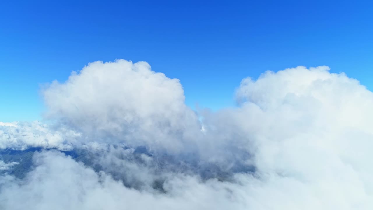 백색 구름이 빅토리아 주 불러 산에서 파란 하늘을 가로질러 굴러가고 있다.