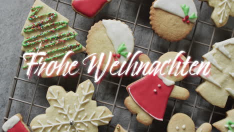 Frohe-Weihnachten-Text-In-White-Over-Decorated-Christmas-Cookies