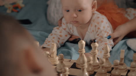 la niña tiene curiosidad por el ajedrez.