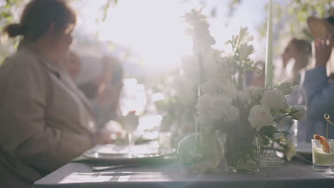 friends lunch in garden in sunny summer day marry women are having dinner in nature