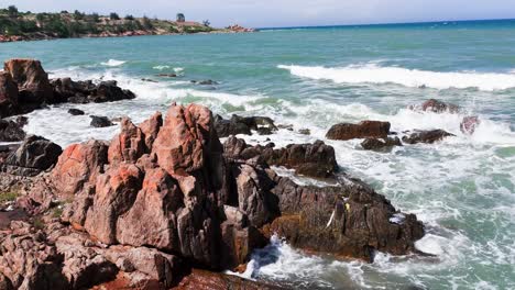 aerial view tilt of the rocks at the beach in lam dong