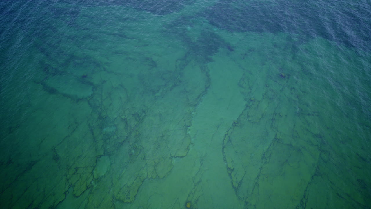 Aerial View of Clear Ocean Water Over Rocks