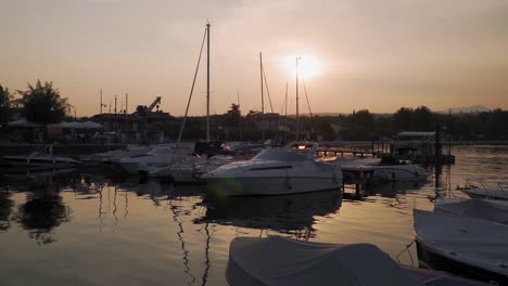 serene scenery of small lake garda port at sunset, shiny water surface rippling