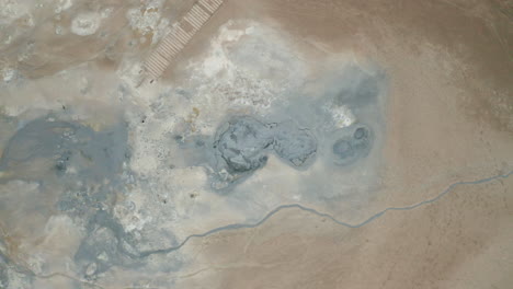 top-down view of boiling and bubbling pools of mud in hverir near lake myvatn in iceland