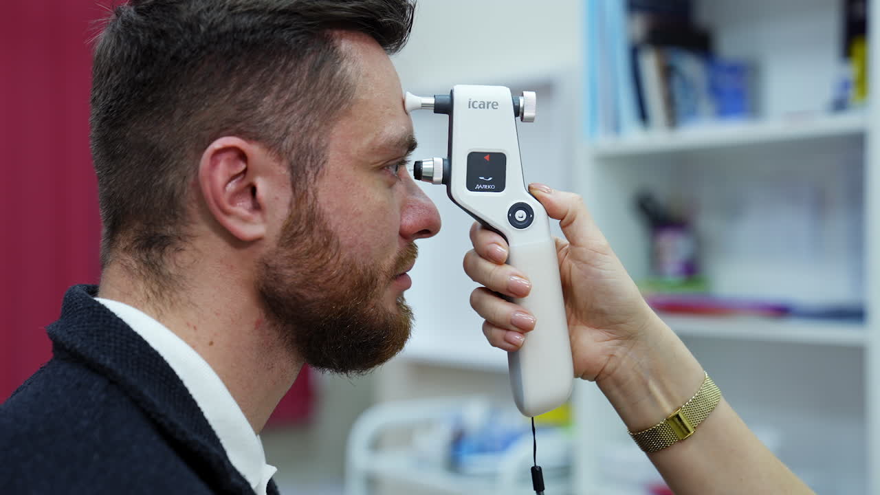 Doctor examining eyesight of patient. Man looking at eye test machine in ophthalmologist