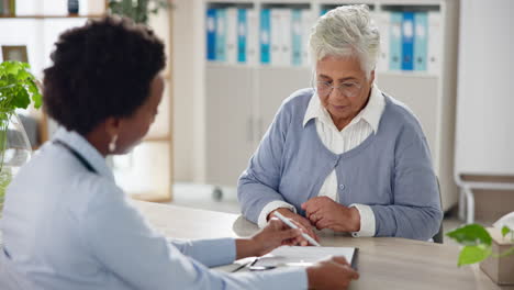 doctor consulting with elderly patient in office