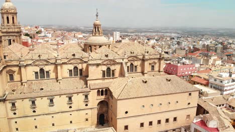 Spain-Jaen-Cathedral,-Catedral-de-Jaen,-flying-shoots-of-this-old-church-with-a-drone-at-4k-24fps-using-a-ND-filter-also-it-can-be-seen-the-old-town-of-Jaen