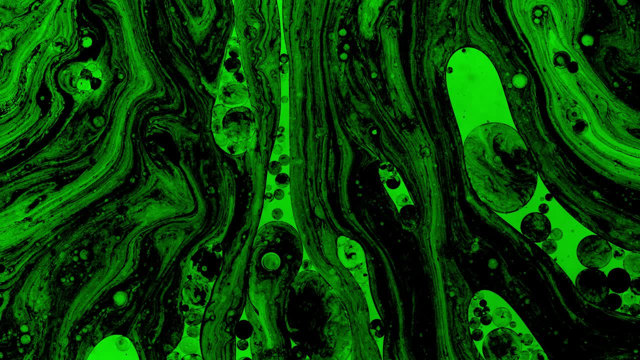 Colorful oil drops floating on water surface, top view. Fantastic abstract background. Bright bubbles moving and spreading. Close up 4k video of weird liquid structures. Scientific chemical experiment