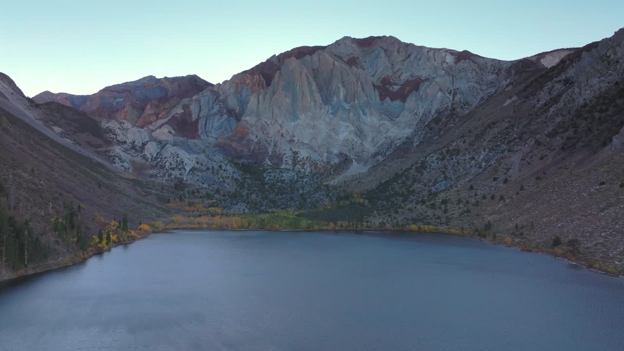 Convict Lake Canyon Trail Mammoth Lakes Mountain aerial drone California autumn fall later afternoon shaded rugged valley peaks yellow Aspen Birch trees clear skies Sierra Nevada range forward upwards