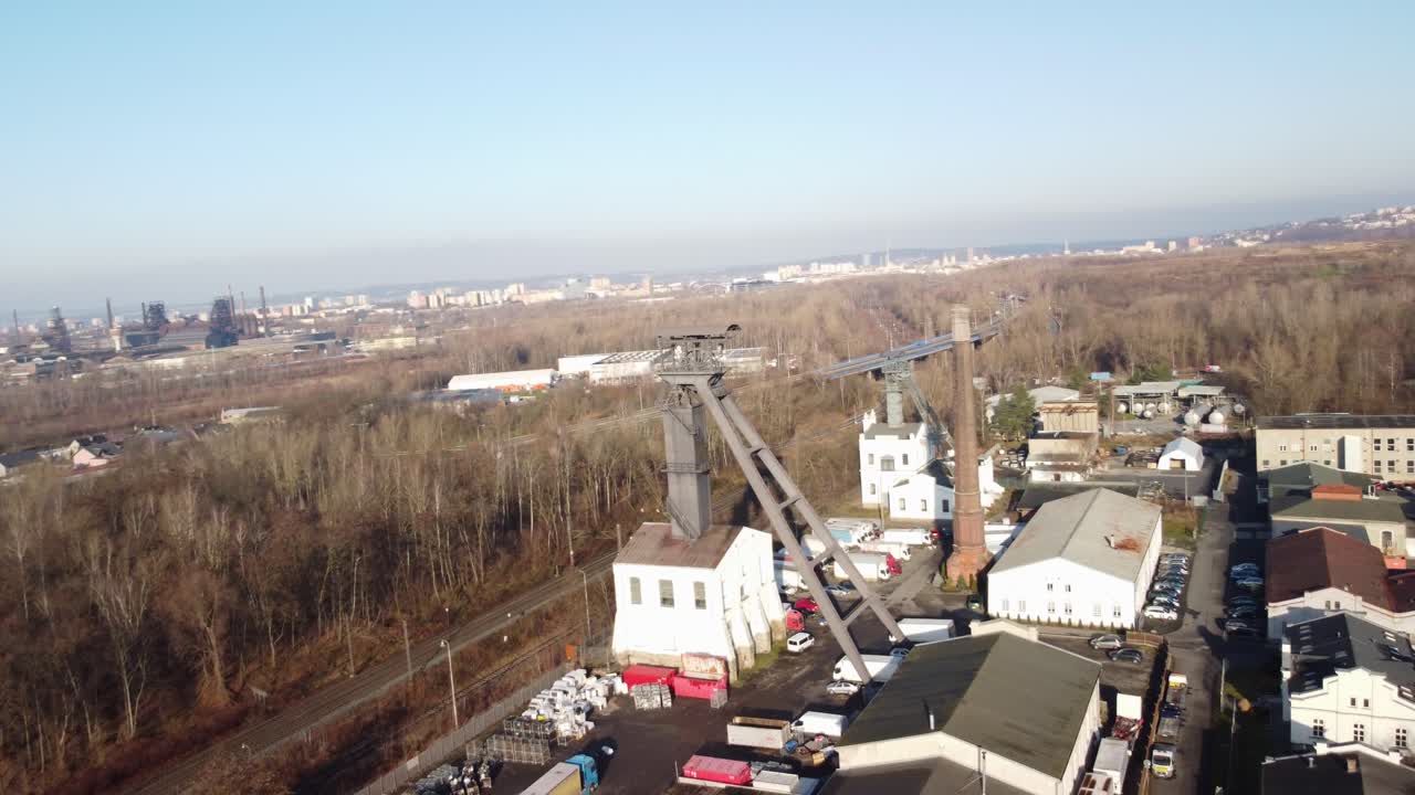 Defunct mining facility in Ostrava shown from above with smoke stacks and barren winter trees