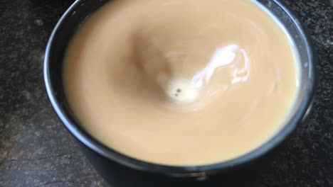 stirring a cup of coffee