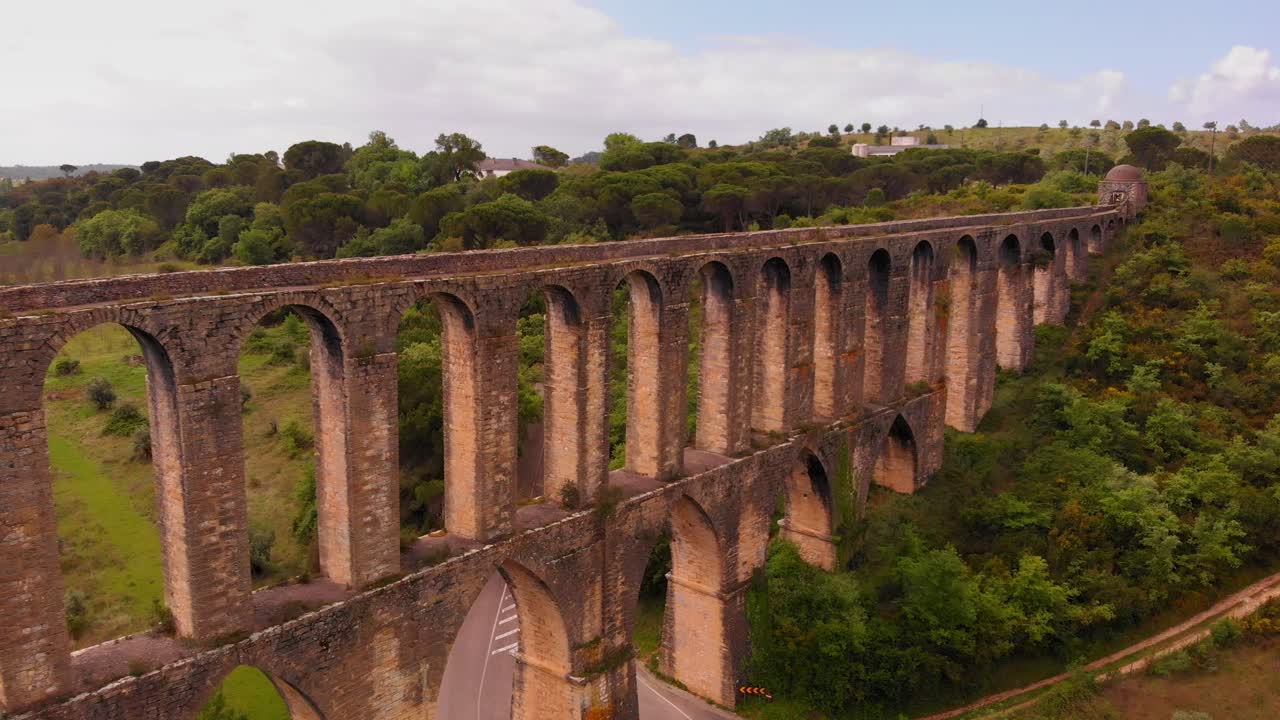 Aerial dolly shot ancient roman aqueduct with many arches, Nature environment