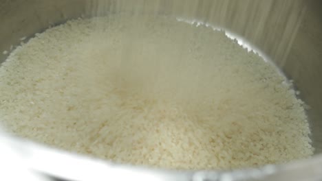 filling bowl with dry rice