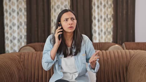 angry indian woman shouting on someone on call