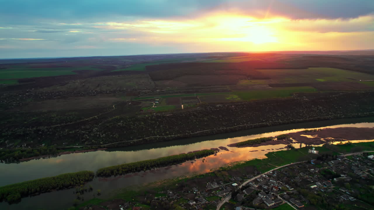 Aerial drone view of Dniester river in Moldova at sunset. Village Saharna and greenery around