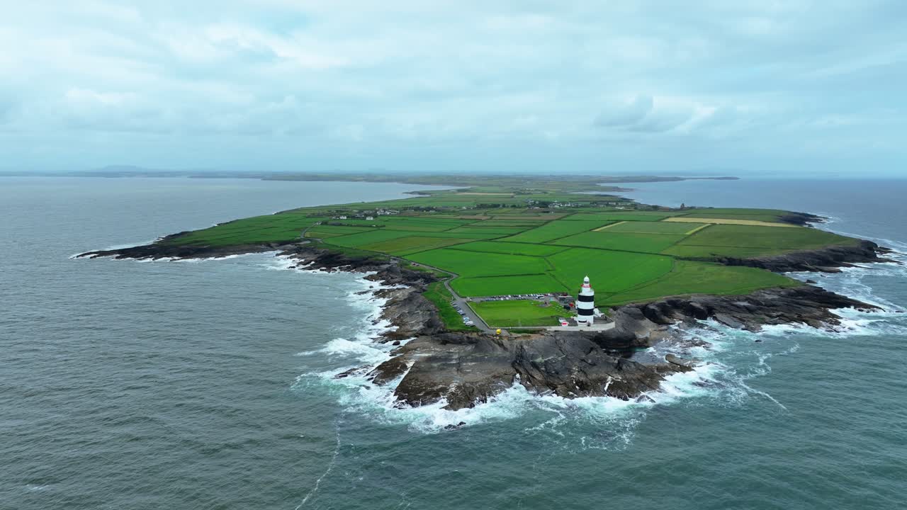 Wexford Epic locations drone orbit from far out at sea of Hook Head Peninsula and Lighthouse stunning view Ireland Landscapes