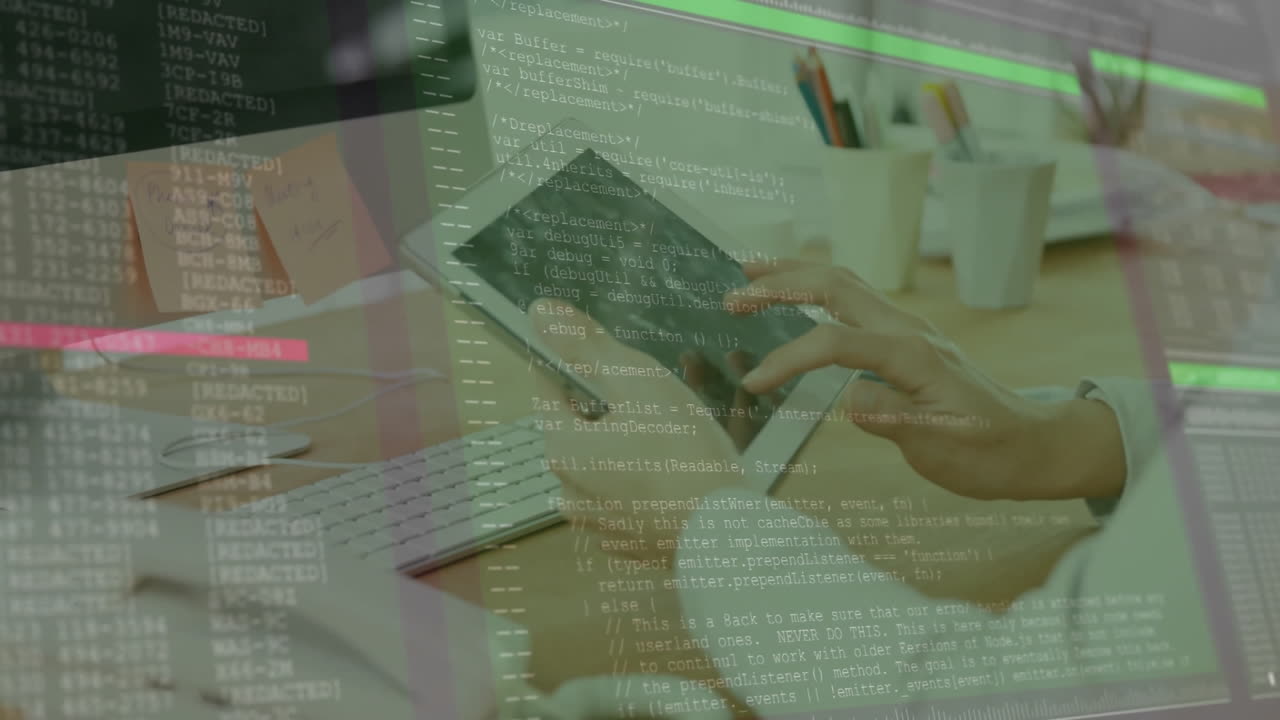 Holding tablet over computer code, hands working on animation in office desk
