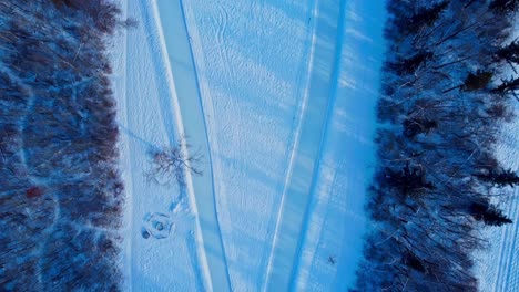 aerial winter twilight birds eye view flyover edmonton's victoria park manmade ice skating race track with firepit side seating that connects to canada's largest outdoor municipal estate ab arena2-4