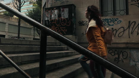 girl climbing stairs with a suitcase