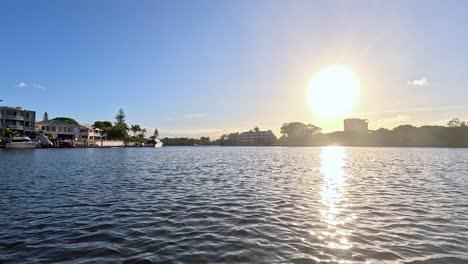 boat cruising during sunset on gold coast river