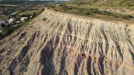 Limestone-headland-cliff-on-the-edge-of-Praia-da-Luz,-Algarve