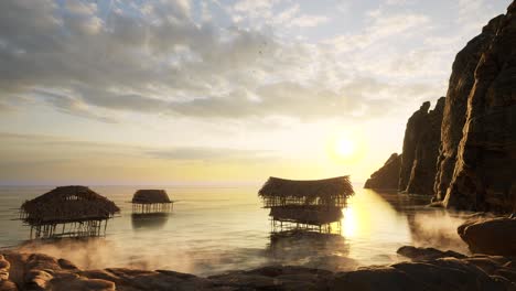 Old-reed-huts-in-the-sea-with-coastal-cliffs-on-sunset,-3D-animation-camera-zoom-in