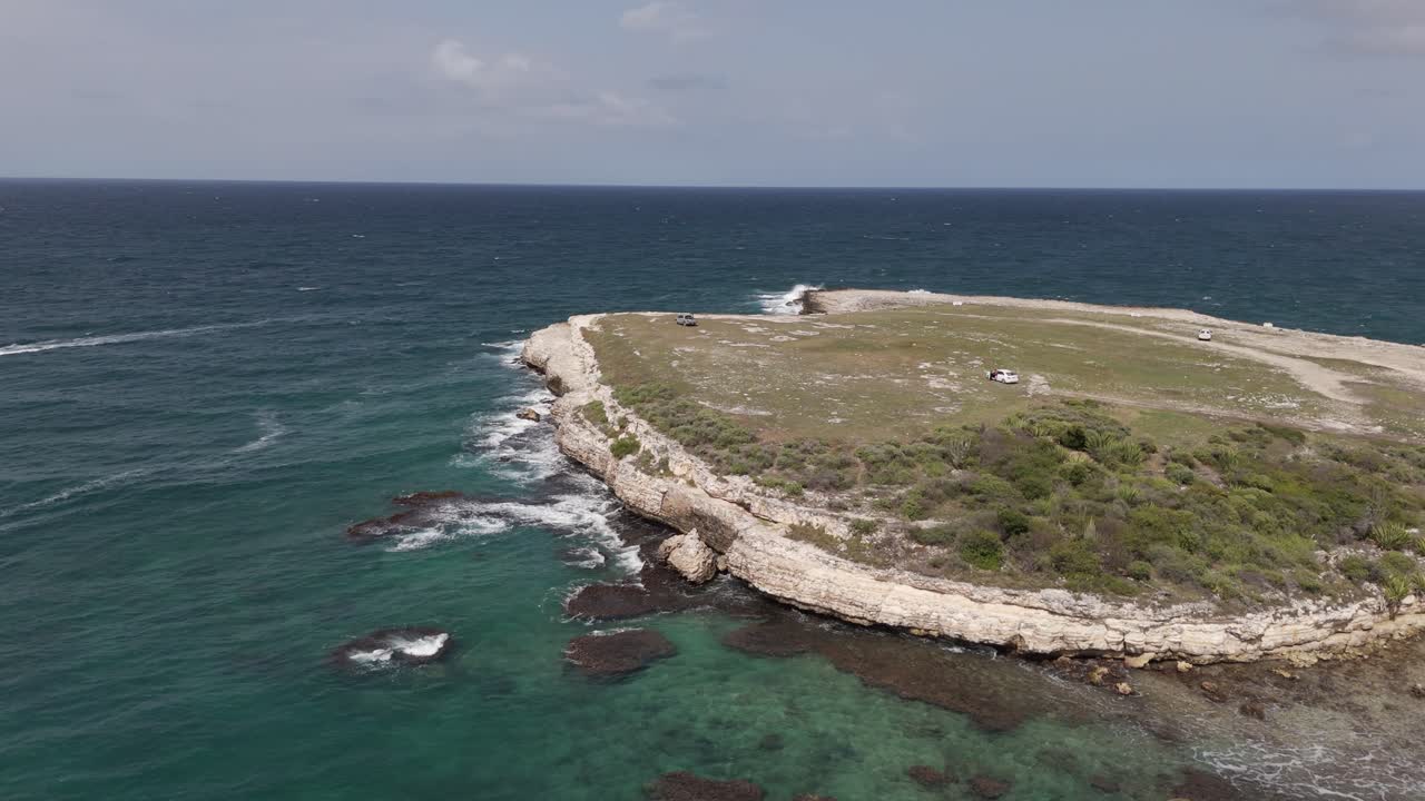 Aerial View of a Rocky Coastline with Cars