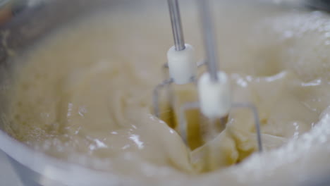 close-up of mixer blades mixing pancake batter