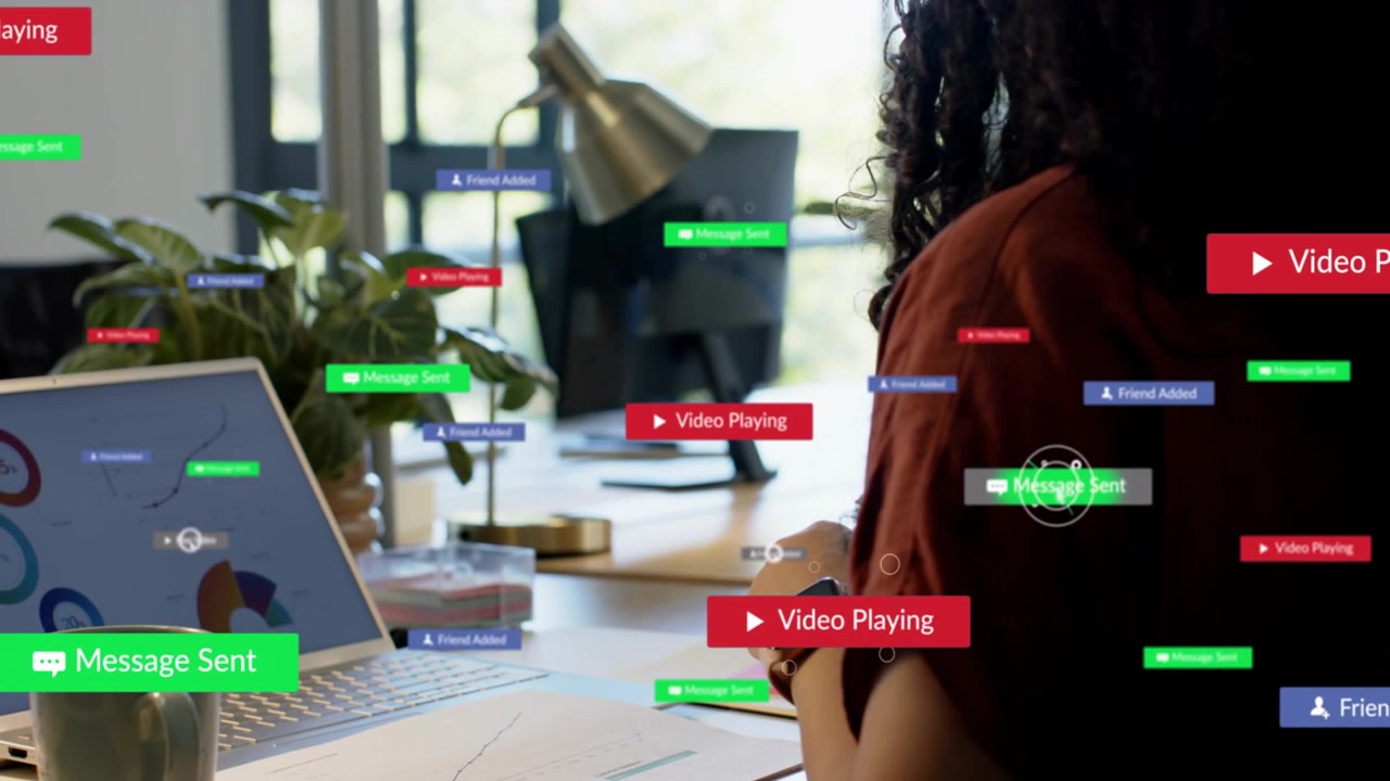 Female pro glancing from business charts to laptop, labels appearing guiding her to phone to reply