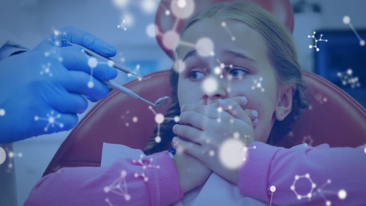 Animation of molecules over caucasian male dentist and girl patient