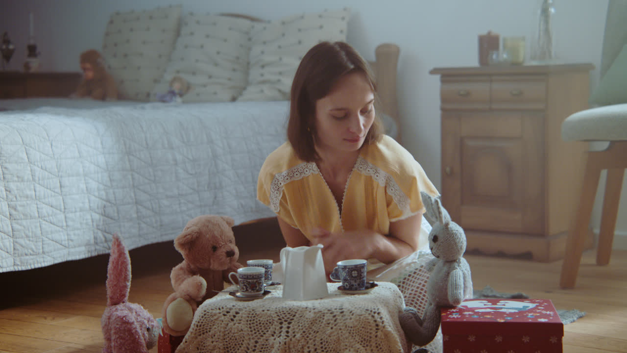 A girl playing with dolls in her room