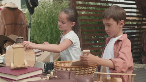 cute siblings preparing for garage sale