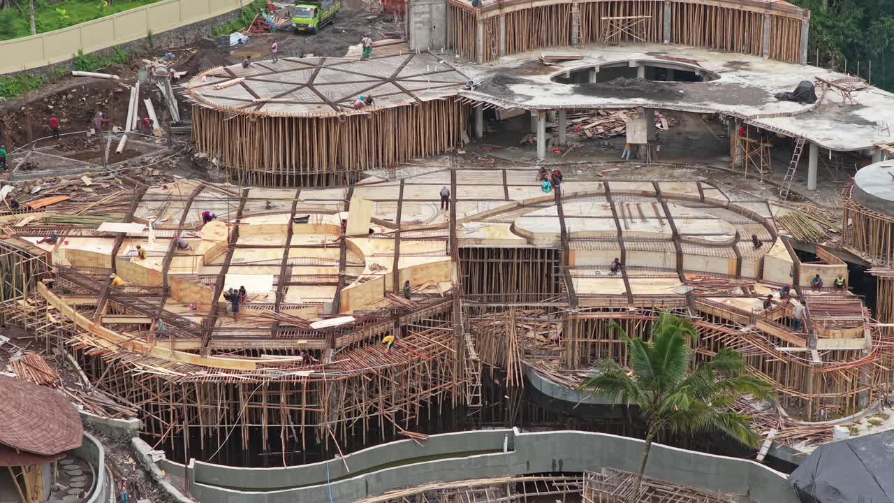 Aerial view of a large construction site with many workers