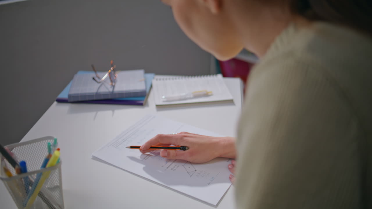 Student girl preparing exam at apartment closeup. Smart woman doing homework