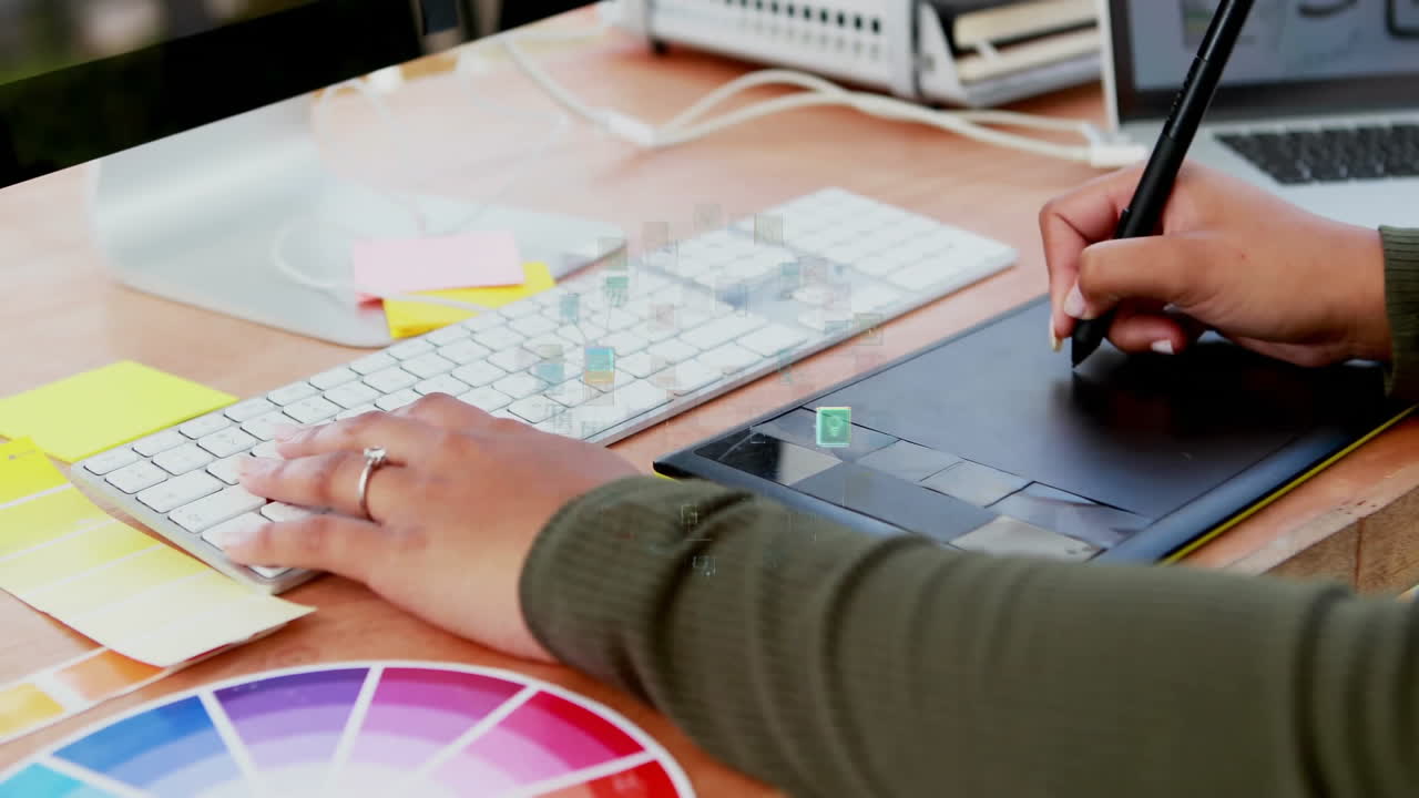 Using digital pen tablet, person editing graphics over color palette animation