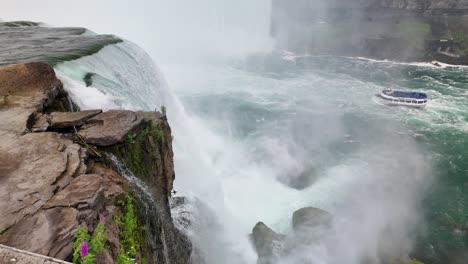 close aerial view of niagara falls waterfall with rushing white water and rising mist. close aerial view of niagara falls waterfall with rushing white water and rising mist