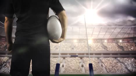 jugador de rugby serio sosteniendo la pelota