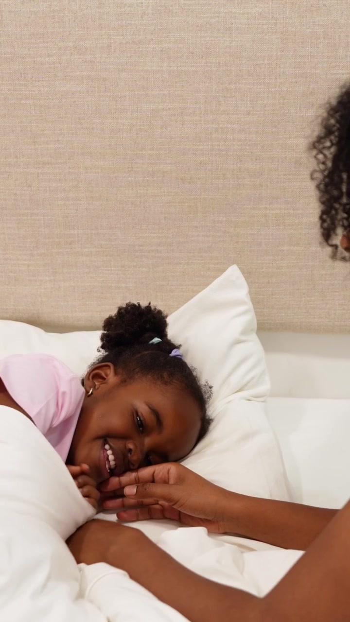 Mother Comforting Her Young Daughter in Bed